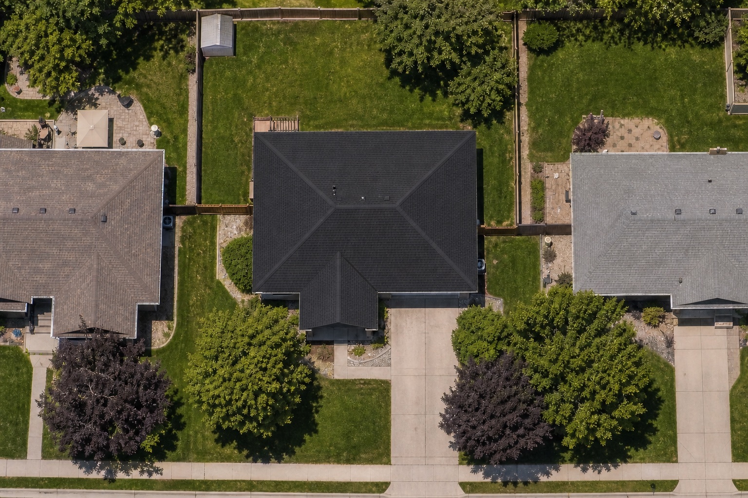 Aerial view of the same property with a newly replaced dark roof